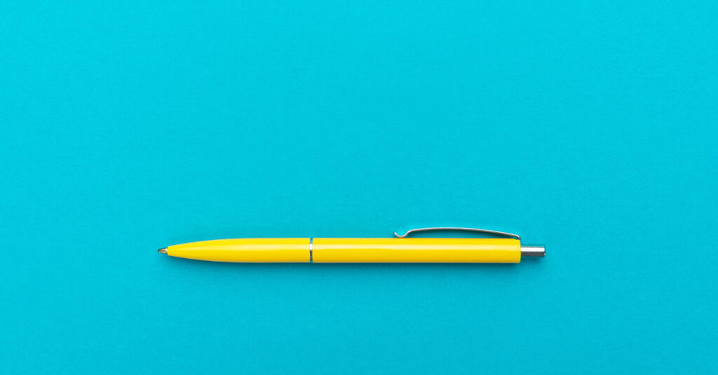 a yellow pen on a turquoise background