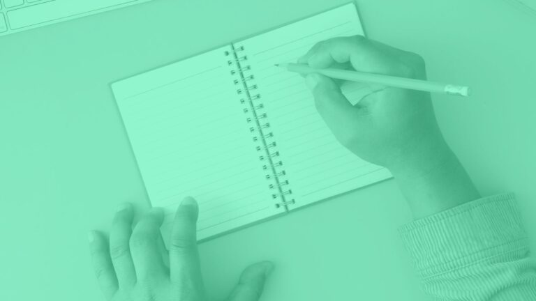 hands writing on a blank page, monochrome with green overcolour
