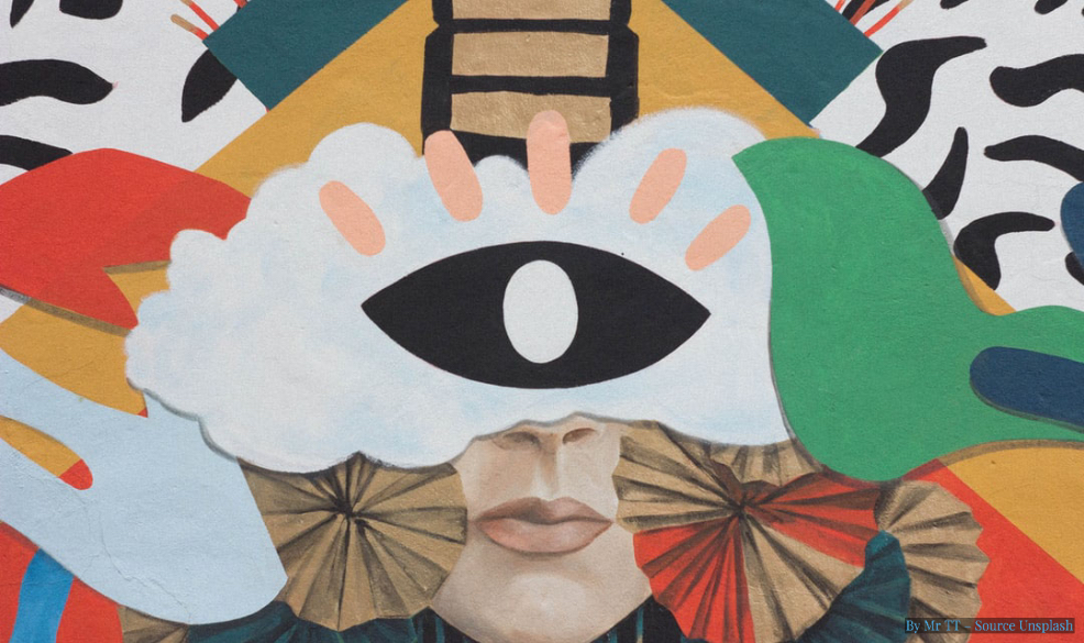 a bright collage of a human face with a large paper eye, and other abstract shapes